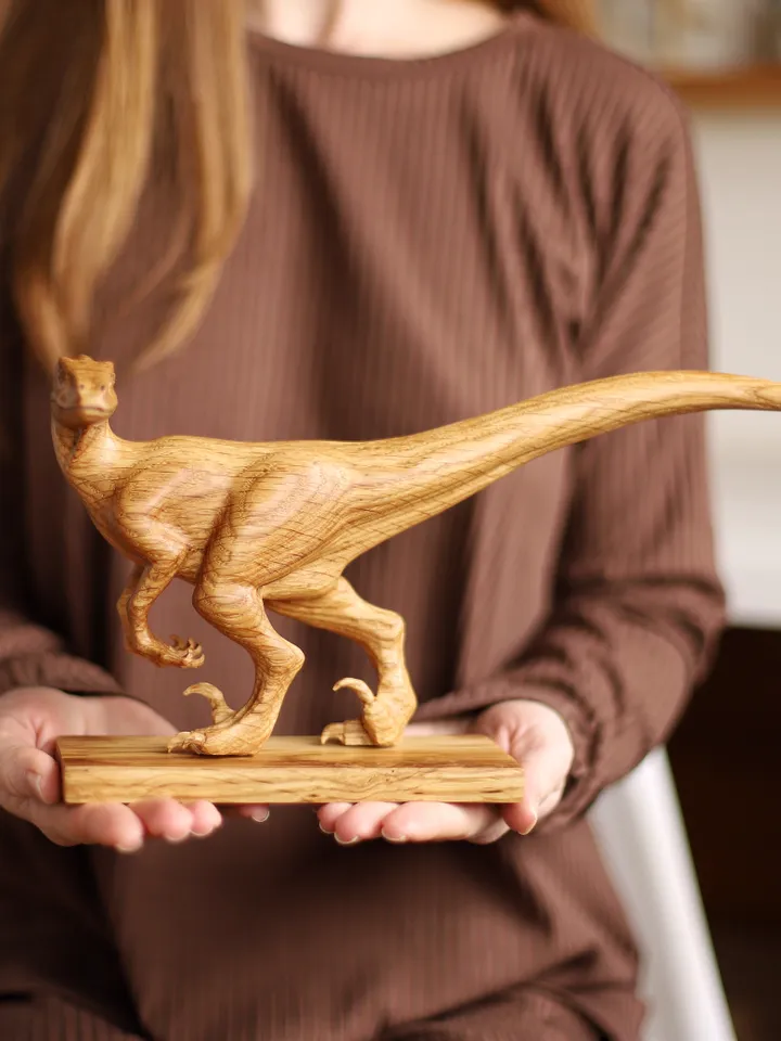 Wooden hand carved dinosaur velociraptor