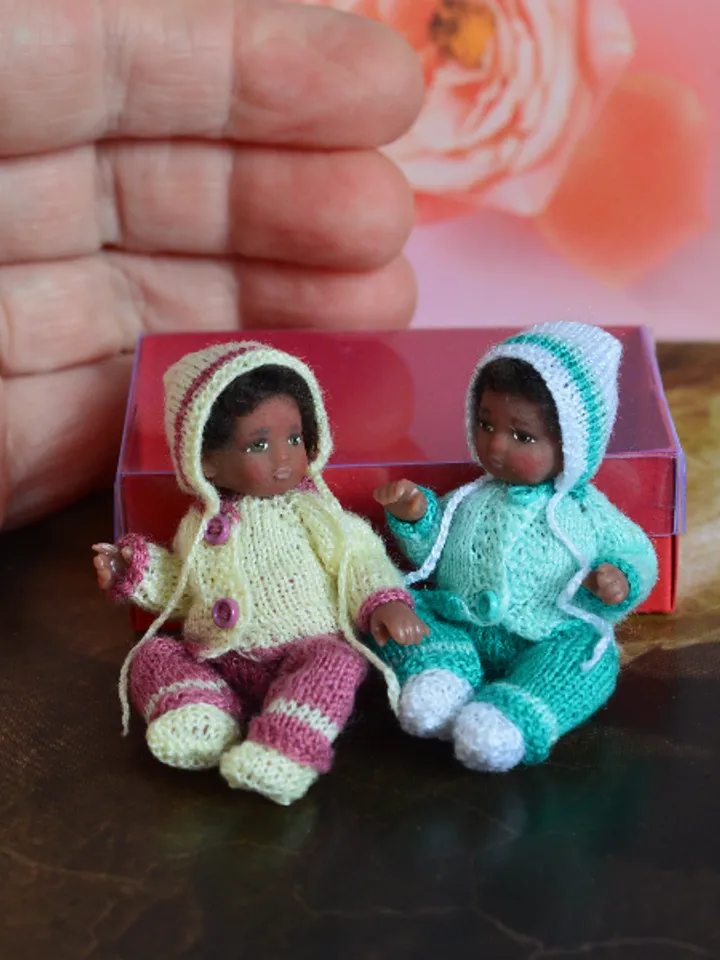 Miniature doll child in 12th scales. A baby for the dollhouse. Baby in a blue suit.