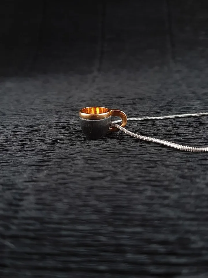 Pendant cup of coffee made of silver with gold plating.