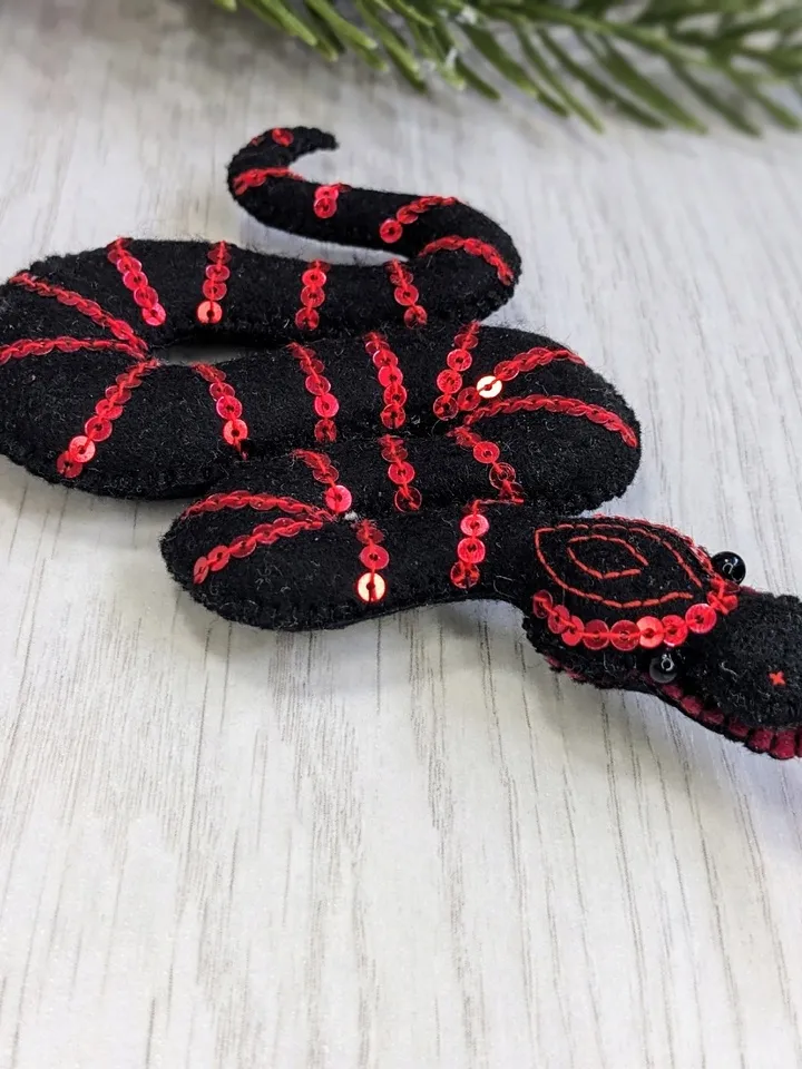 Sinaloyan snake, California king snake. Symbol of the New Year 2025 according to the eastern calendar, a black snake, a Christmas gift.