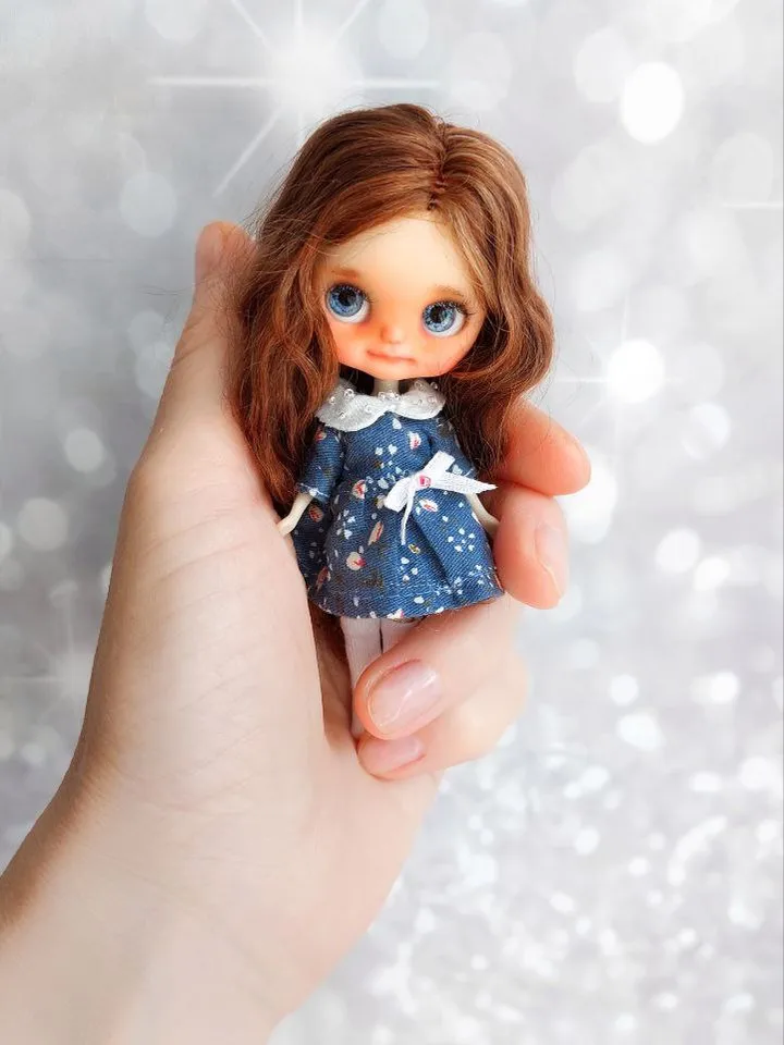 Charming little girl with brown hair and blue eyes. Author's miniature doll for your collection.