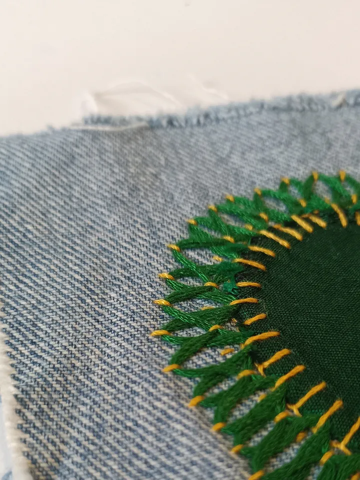 Upcycled denim boro patch – visible mending.