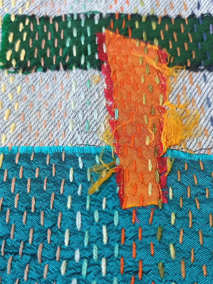 Upcycled denim boro patch – visible mending.