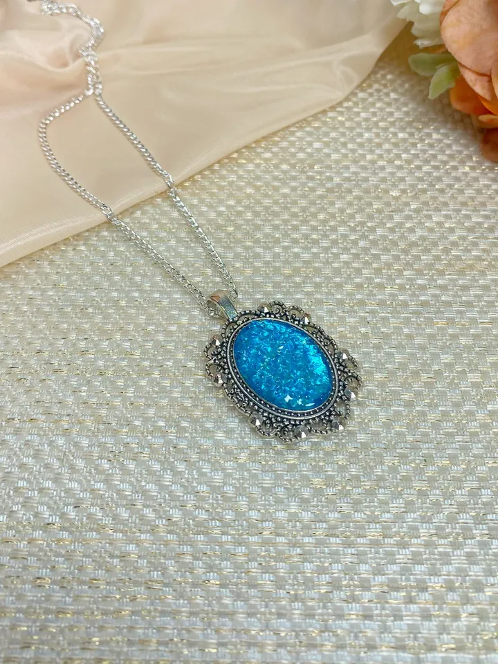 Bright, turquoise pendant on a handmade cord. Handmade jewelry with turquoise rhinestones.