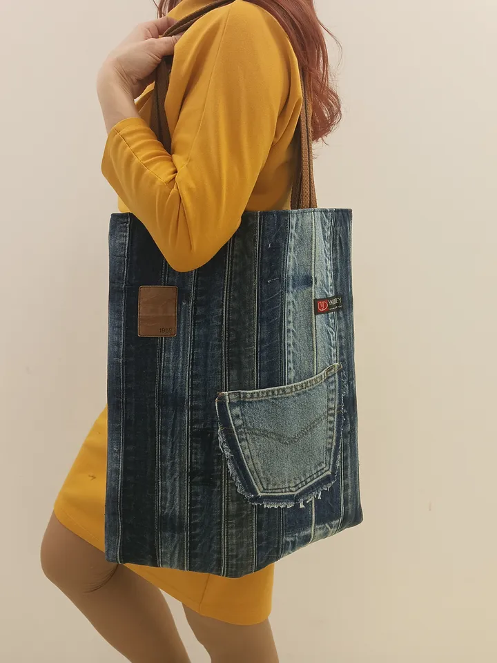 Large denim shopper, shopping bag, city bag, made from recycled jeans, with comfortable handles 60 cm long. Comfortable to wear on the shoulder. Bag with lining made of black synthetic fabric, 2 pockets and strong handles made of 2-color straps. The front