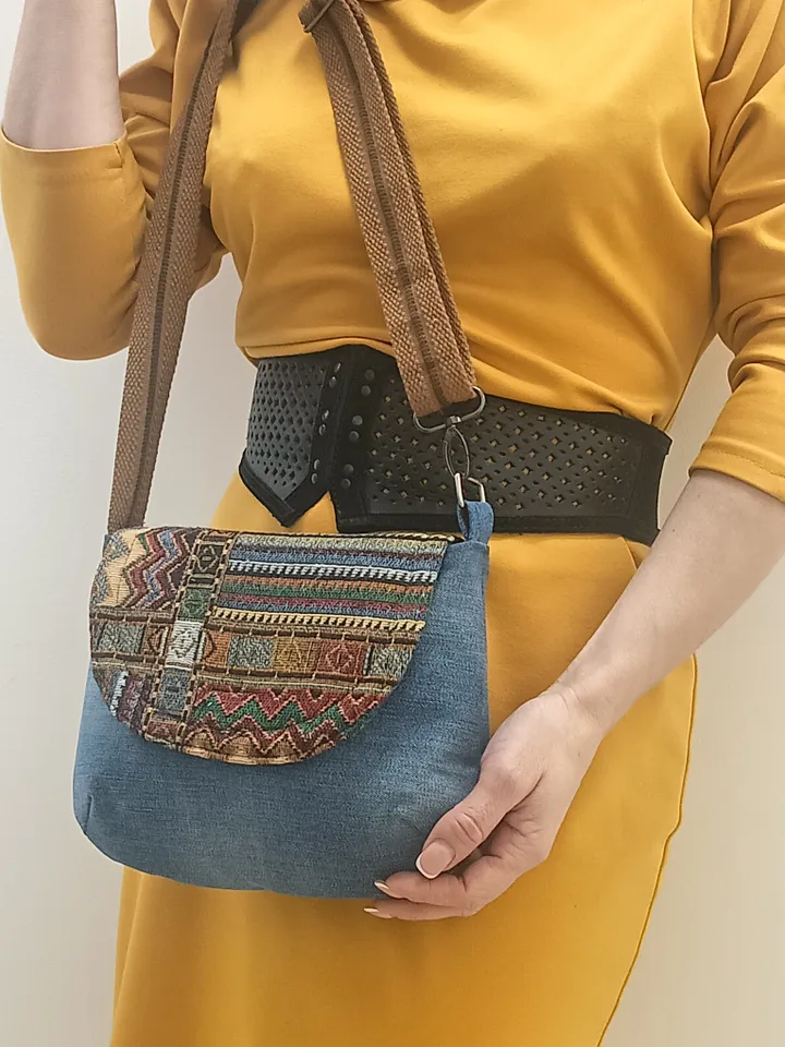 A small crossbody bag, a women's messenger bag with a tapestry flap, a denim shoulder bag with pockets inside and an adjustable strap