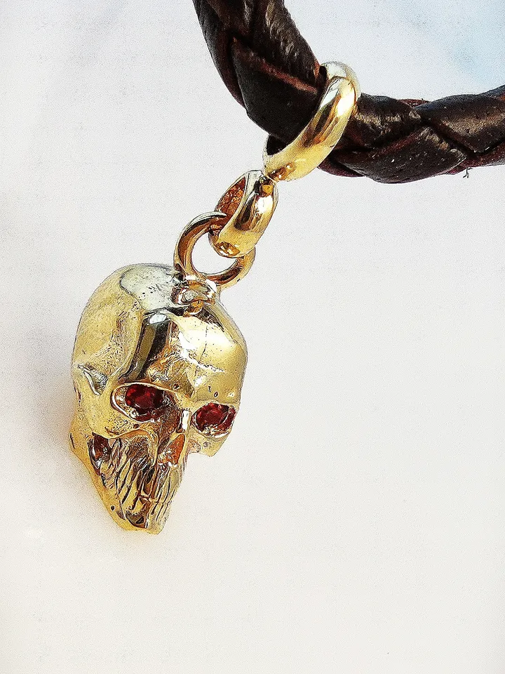 Skull pendant with inlaid natural garnets