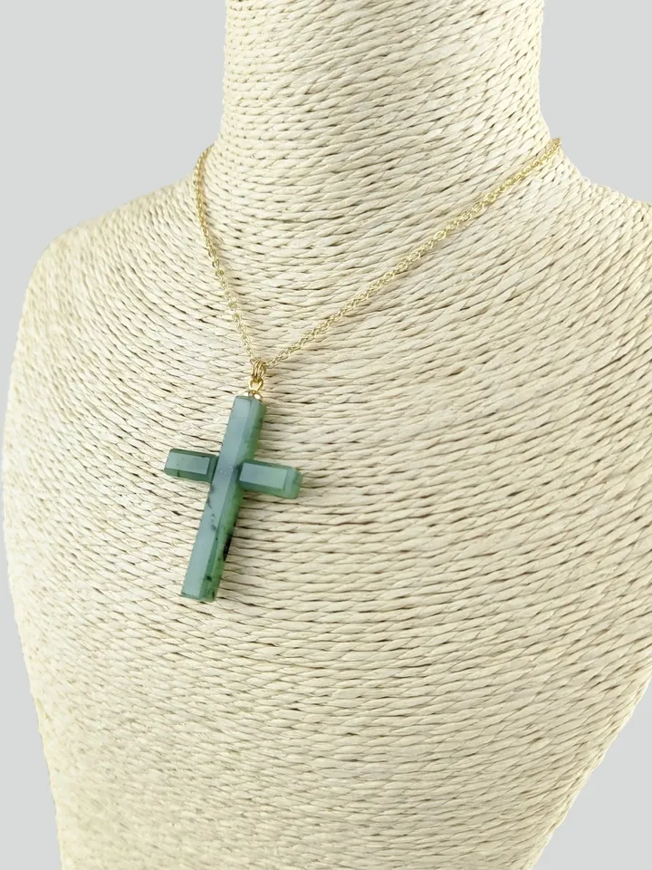 Christian cross pendant green jade on a gold plated chain.