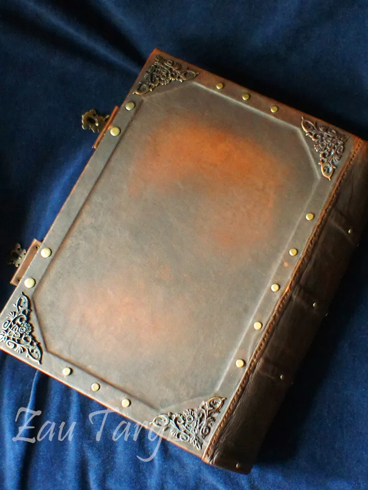 Big brown leather grimoire with a pentagram