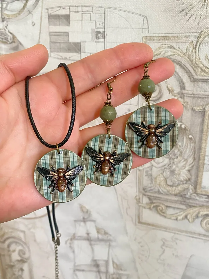 Author's set of handmade jewelry.Earrings and pendant on a cord with voluminous flies.