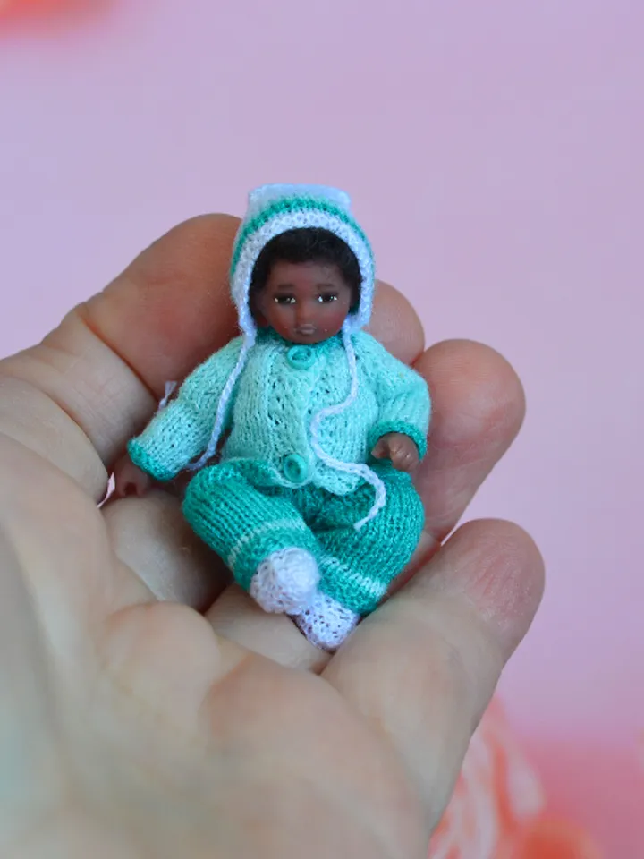 Miniature doll child in 12th scales. A baby for the dollhouse. Baby in a blue suit.