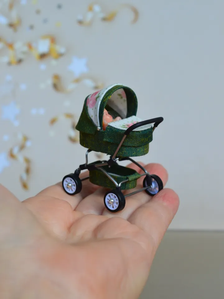 Miniature toy doll stroller in 1/24 scale. Complete with baby doll.