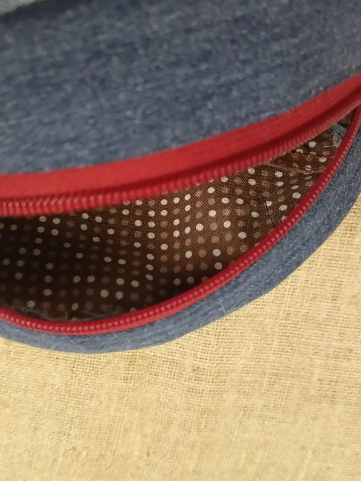 Cute handmade denim round crossbody bag with Red belt, brown polka dot cotton inside, pockets inside and outside, leather zipper stripe, weight only 160 grams, very light. A handbag for walks, excursions, and travel.
