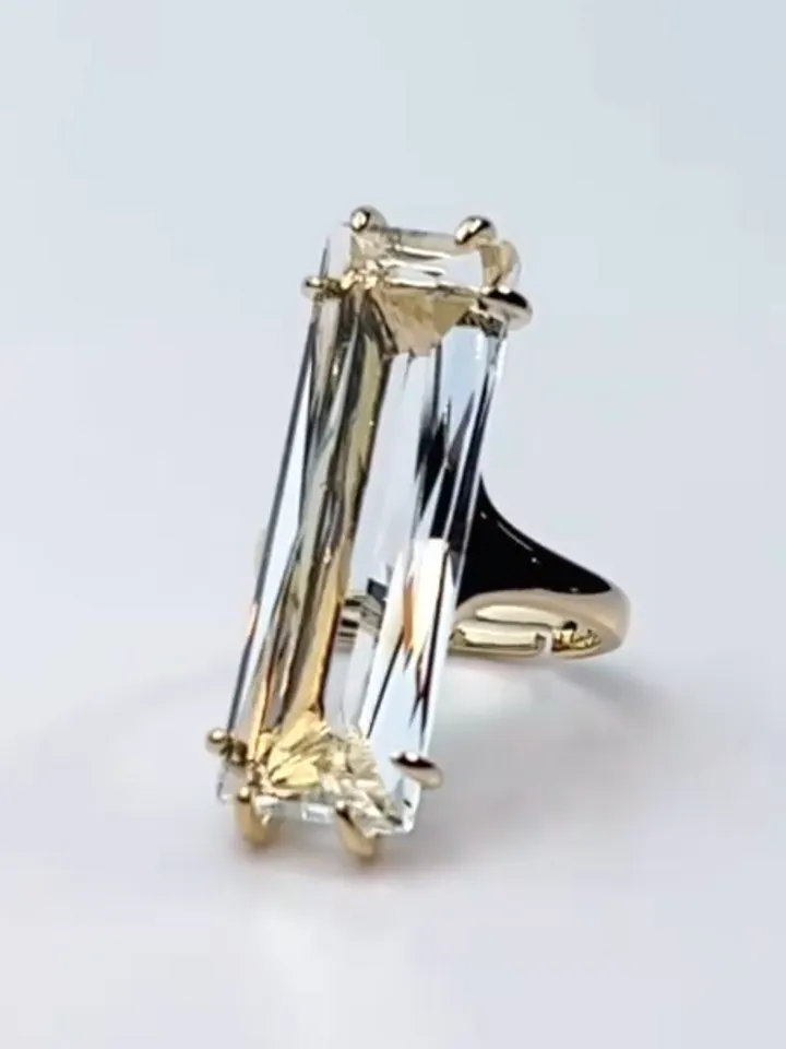 Ring gilded with a large rectangular crystal stone, one-size adjustable 16-20 size