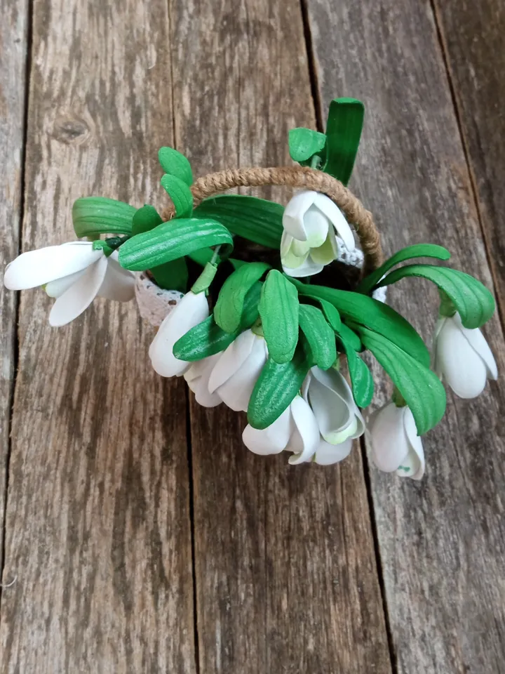 A bouquet of delicate handmade snowdrops in a basket. Mother's day gifts Gifts for her
