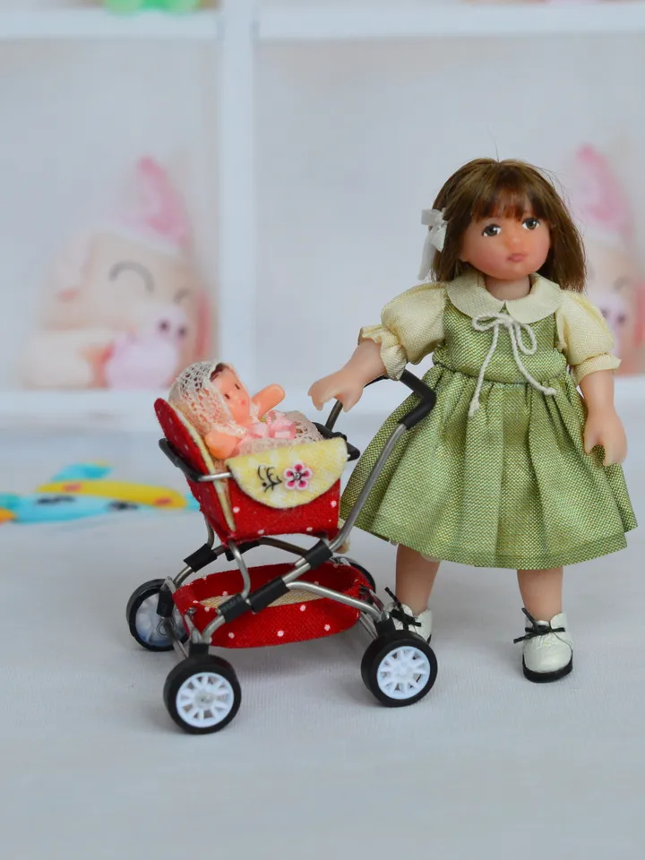 Miniature toy doll stroller in 1/24 scale. Complete with baby doll. Red handmade stroller.