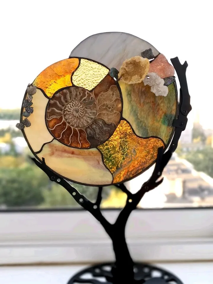 Tiffany Stained Glass: Ammonite with Gemstones on a Branch Stand, Artistic Ammonite with Gemstones in Tiffany Style, Ammonite Fossil with Crystals on a Sculptural Stand, Unique Ammonite Stained Glass Art with Gemstones, Decorative Ammonite with Gemstones