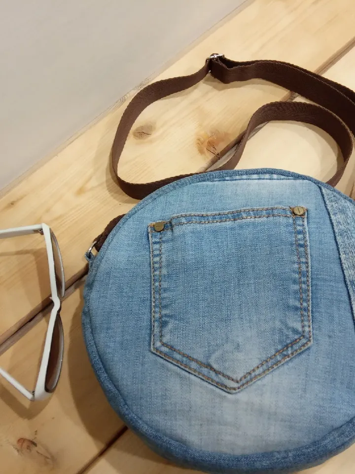 Round denim crossbody bag with a long strap