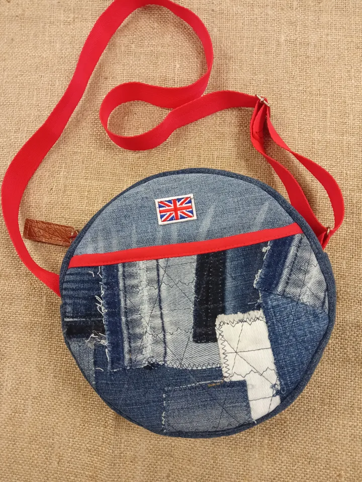 Cute handmade denim round crossbody bag with Red belt, brown polka dot cotton inside, pockets inside and outside, leather zipper stripe, weight only 160 grams, very light. A handbag for walks, excursions, and travel.