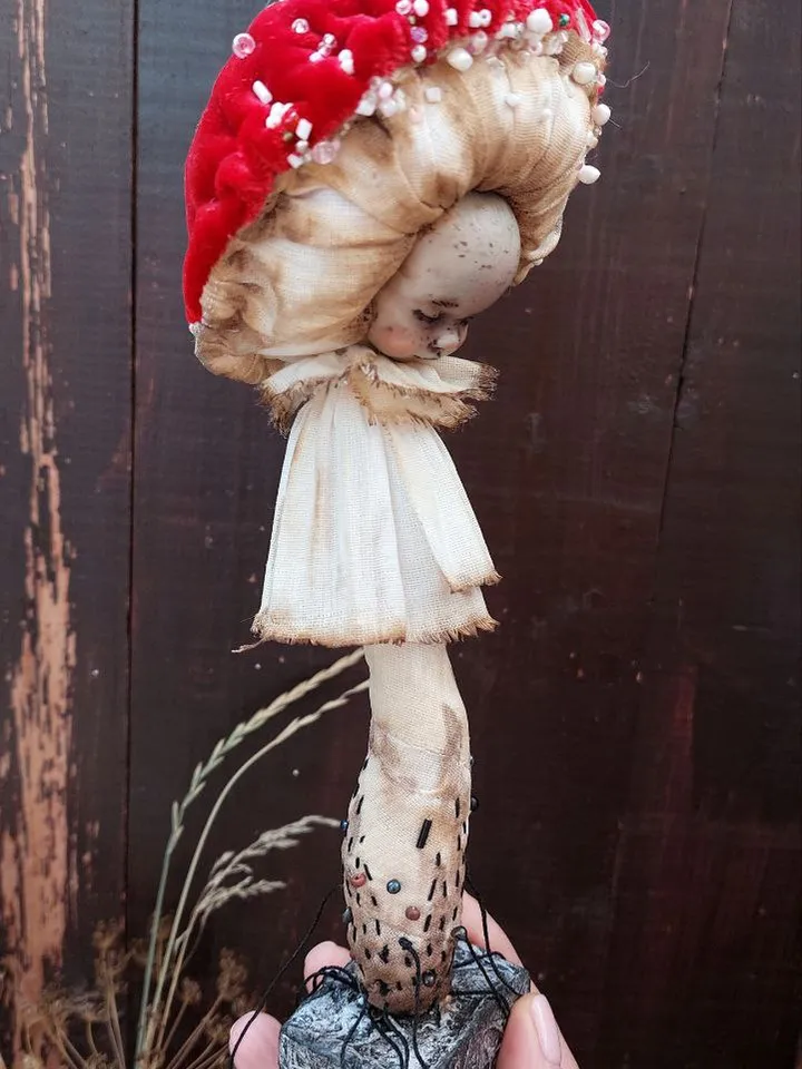 Art doll Mushroom. Unusual handmade statuette. Sleeping child-toy in the image of a fly mushroom. Mushroom is a textile sculpture. Unique statuette made of fabric and polymer clay, decorated with beads and beads. An art object for your interior and collec