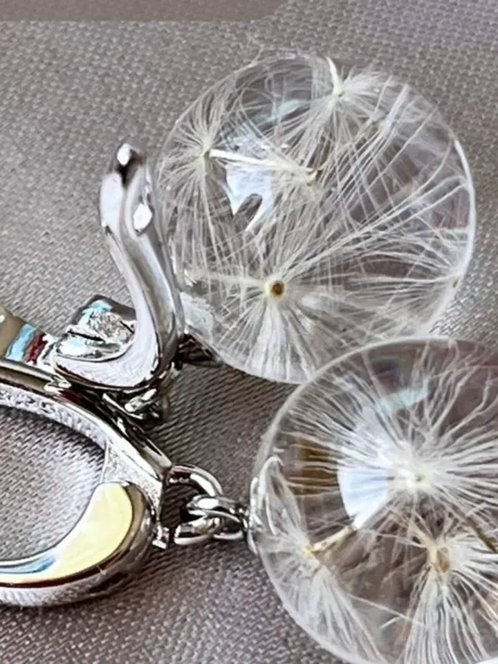 Handmade epoxy resin earrings with dandelion fluffs