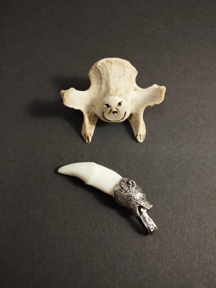 A silver-framed wolverine's fang.