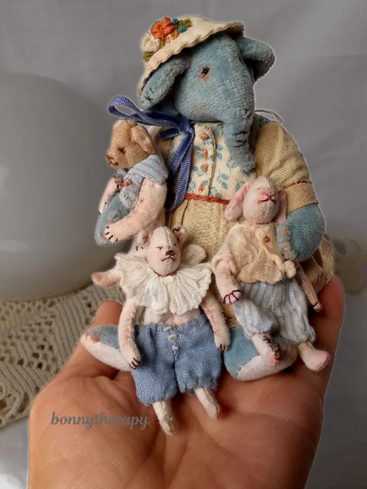 Textile elephant toy with a little friends