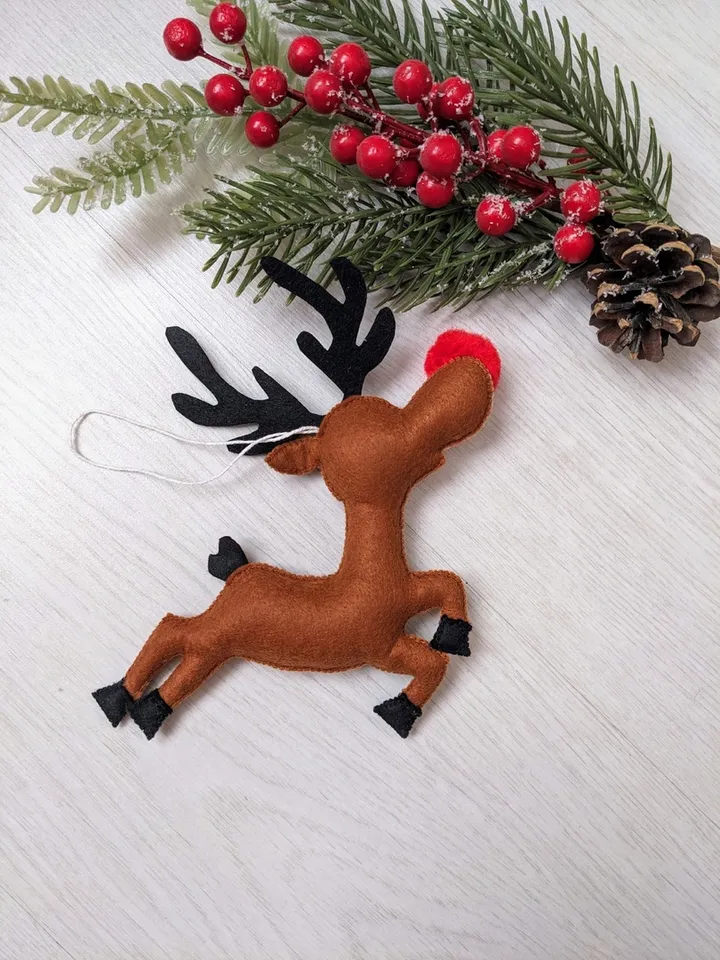 Funny reindeer from Santa's sleigh. Brown felt Deer with a red nose. Christmas gift.