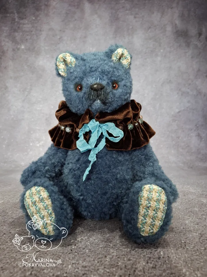 Blue teddy bear. Handmade toy. Plush bear.