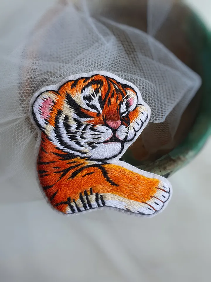 Sleeping Tiger Cub Brooch. Hand-embroidered with satin stitch