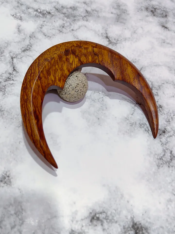 Hair bun pin in the shape of a moon.