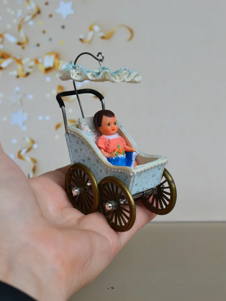 Miniature toy stroller for a little doll. Pram for the little poopsie.