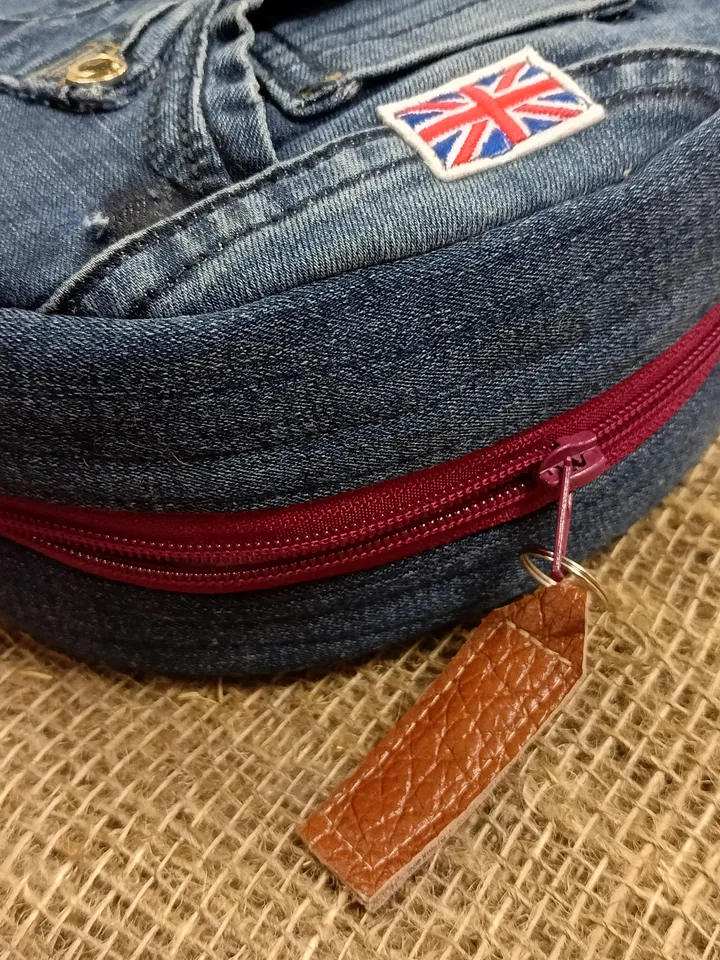 Cute round denim handbag with 5 pockets, adjustable strap and polka dot cotton inside.