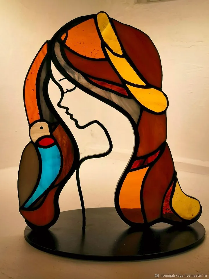 Girl with a Bird. Tiffany Stained Glass, Stained Glass Featuring a Girl and a Bird, Stained Glass with a Girl and Bird on a Stand, Stained Glass "Girl and Bird" on Base, Stained Glass Featuring a Girl and Bird