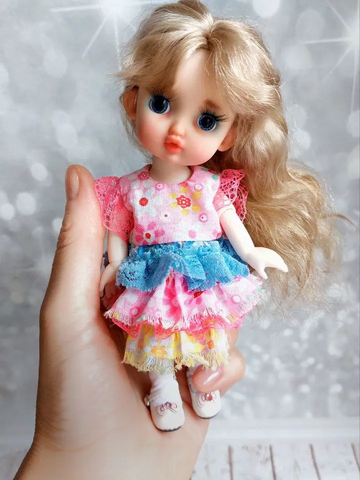 Blonde doll with blue eyes. Small doll on an articulated body.