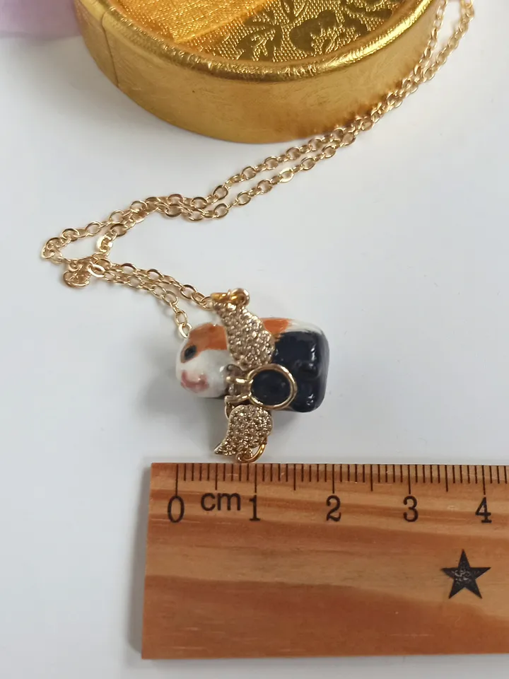 Handmade guinea pig pendant, adorned with rhinestones and gold wings (US discount)