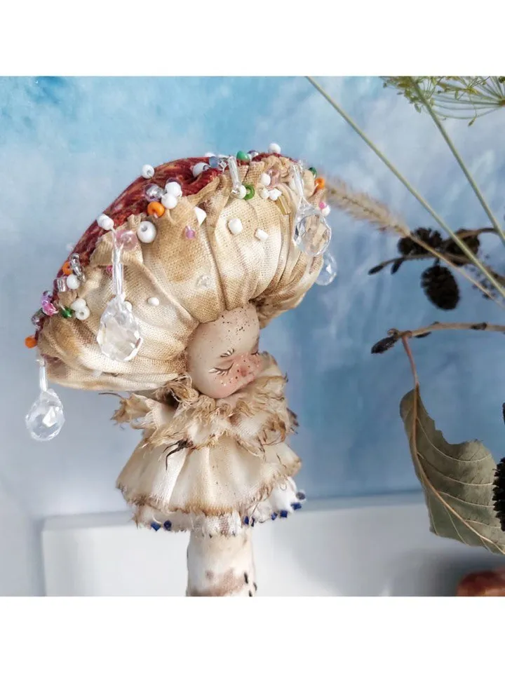 Art doll Mushroom. Unusual handmade figurine. Sleeping child-toy in the image of a fly mushroom. Unique statuette is made of fabric and polymer clay, decorated with beads and beads. An art object for your interior and collection