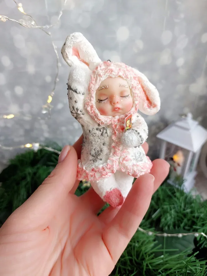 Cute Christmas tree toy made of cotton sleeping bunny. Handmade hanging toy. A gift for Christmas.