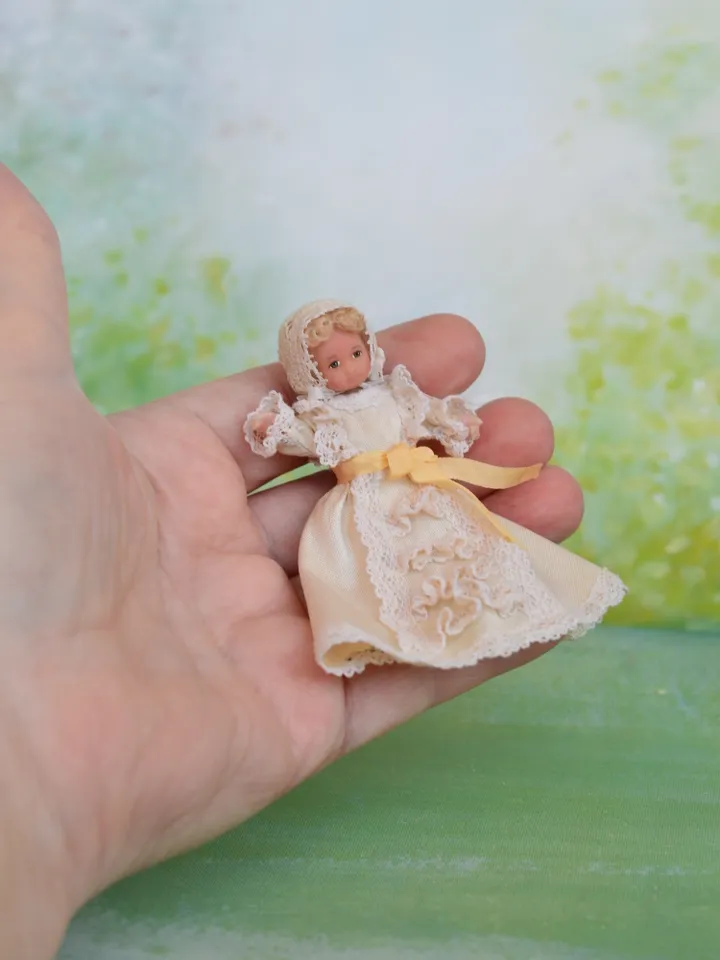 Miniature baby doll for Victorian dollhouse in 1/12 scale.