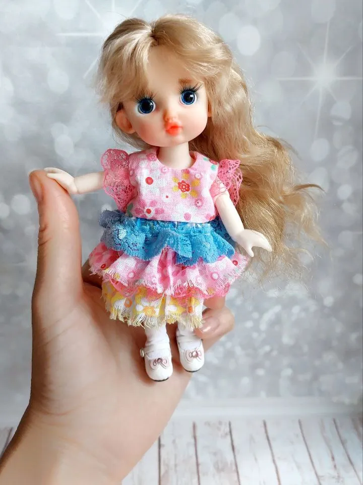 Blonde doll with blue eyes. Small doll on an articulated body.