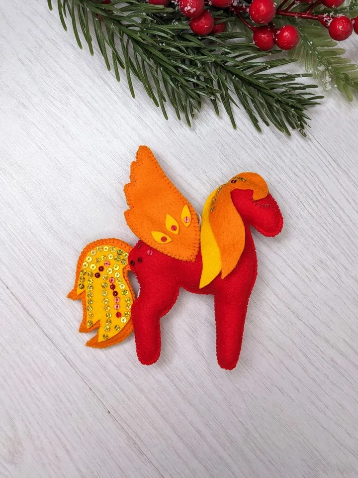 Pegasus in ancient Greek mythology is a winged horse, a favorite of the muses. Felt toy Red fiery Pegasus