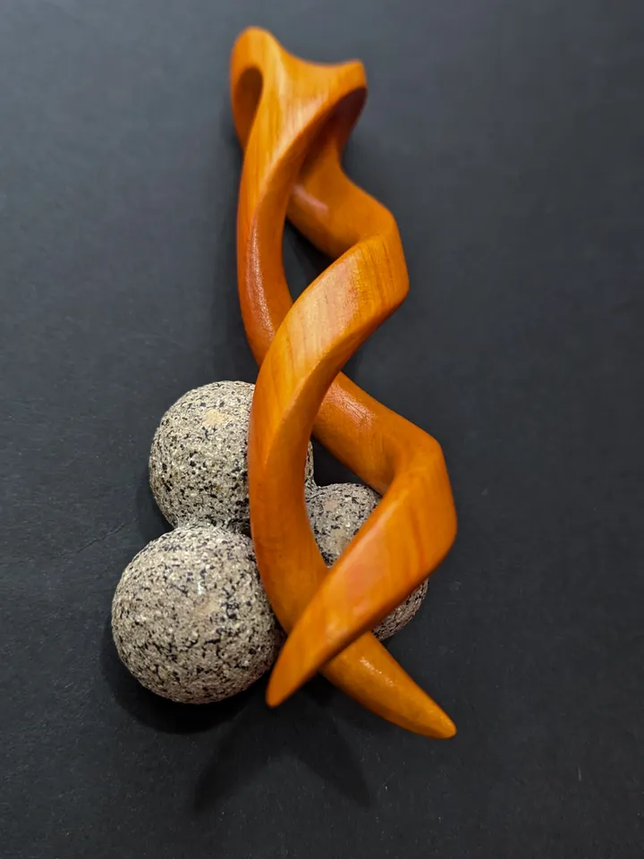 Spiral clip made of stabilized hornbeam orange. Twisted wooden hair fork.