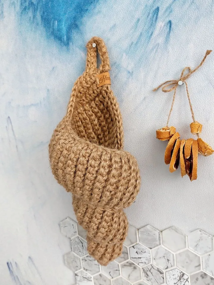 A hanging basket in the shape of a sea shell.
Handmade crocheted seashell made of jute.
Eco-friendly decor in a nautical style. Use the basket as a cachepot for small flowers, organizer for cosmetics, for combs and other items.