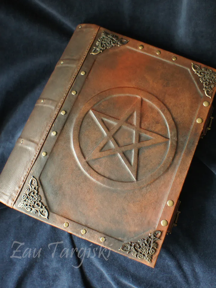 Big brown leather grimoire with a pentagram
