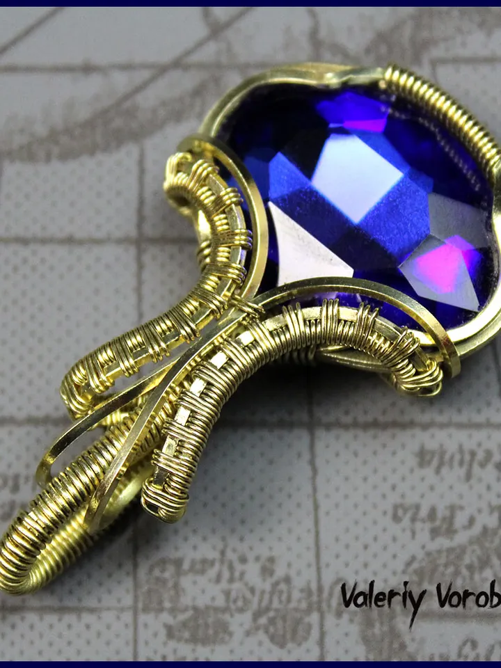 Handmade pendant made of brass wire and cut glass.
