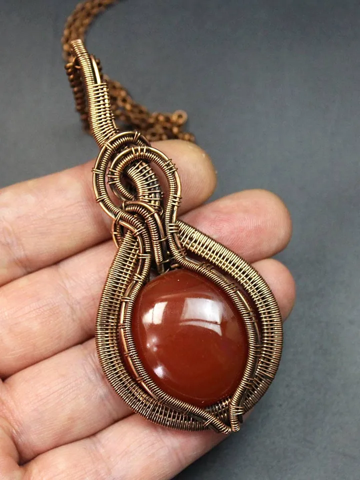 Handmade Pendant made of copper wire and natural carnelian stone