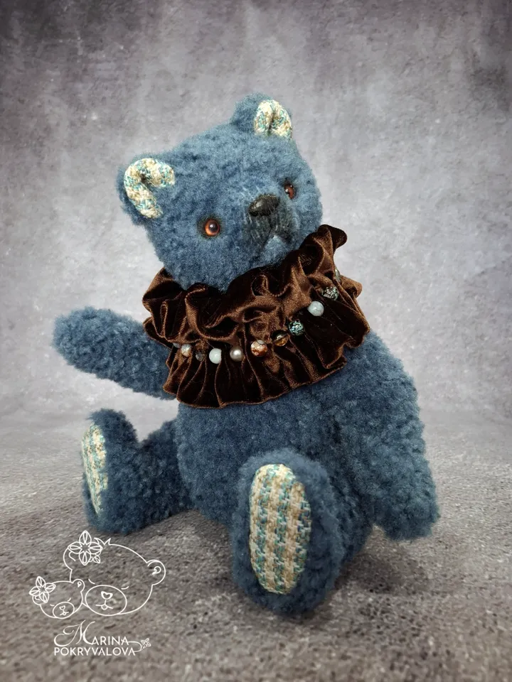 Blue teddy bear. Handmade toy. Plush bear.