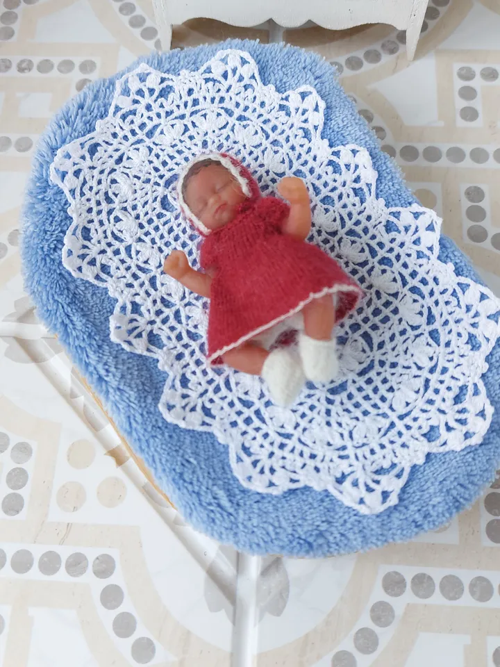 Miniature knitted red dress with white pants, socks and a hat for the silicone doll "My Mini Baby" by ZURU