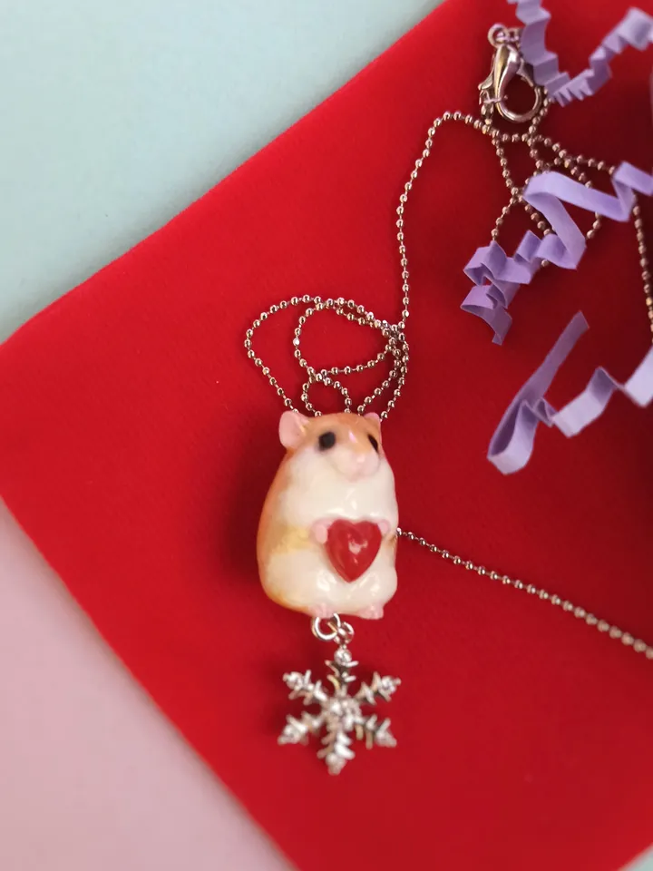 A small handmade hamster necklace in red and white color