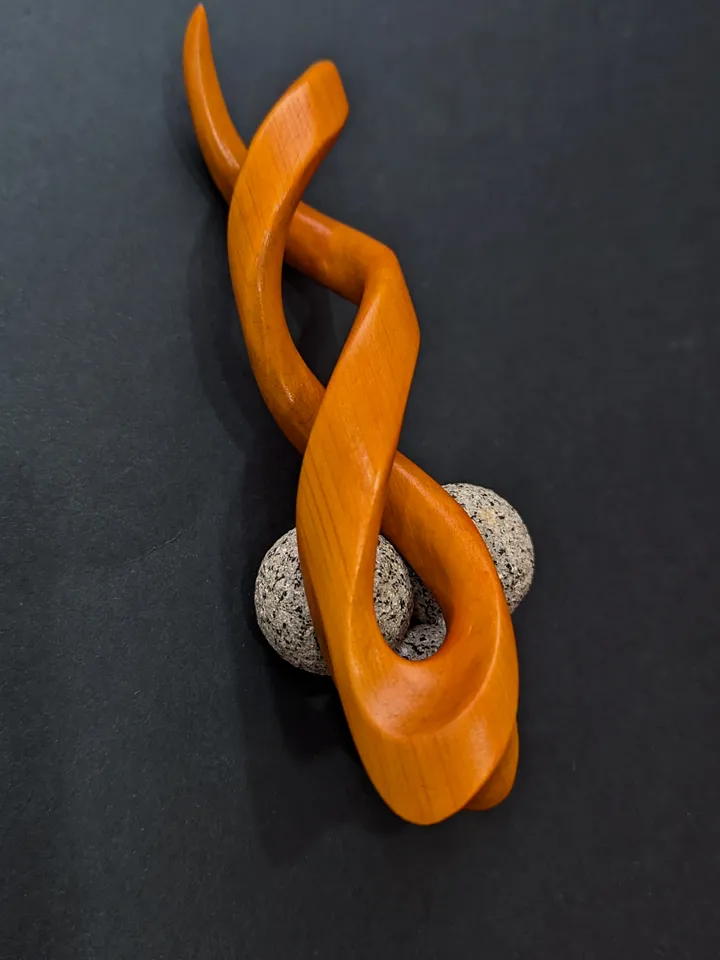 Spiral clip made of stabilized hornbeam orange. Twisted wooden hair fork.